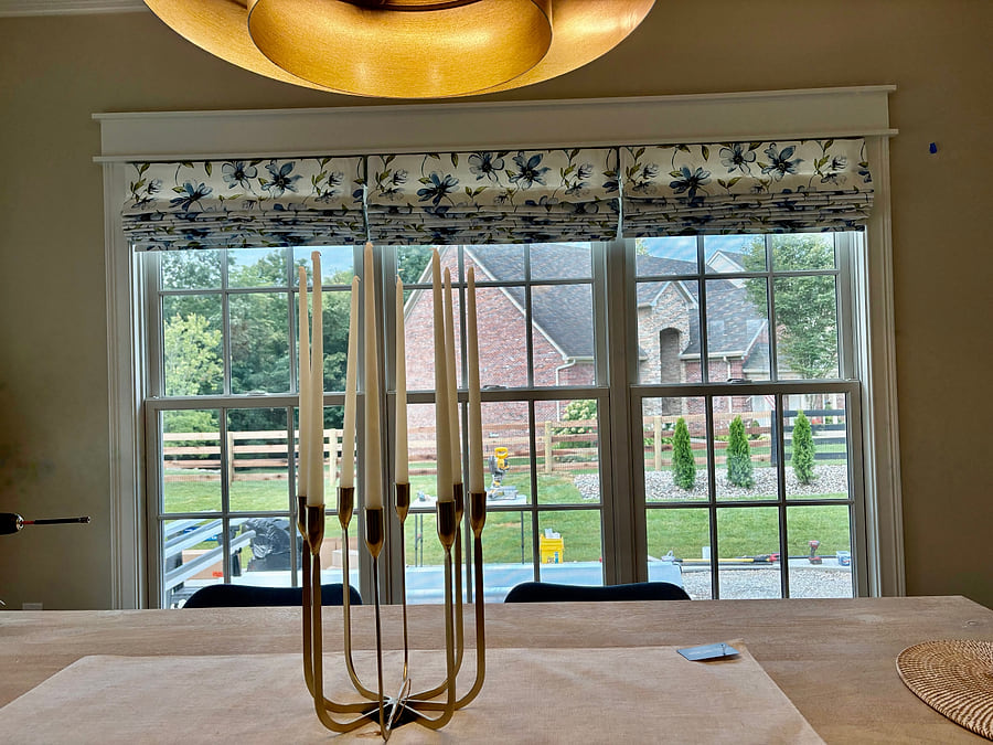 Three matching roman shades above a run of kitchen windows