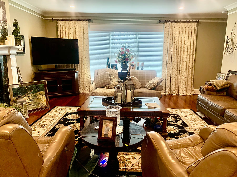 A living room before its refresh, with the previous paint, furnishings and draperies