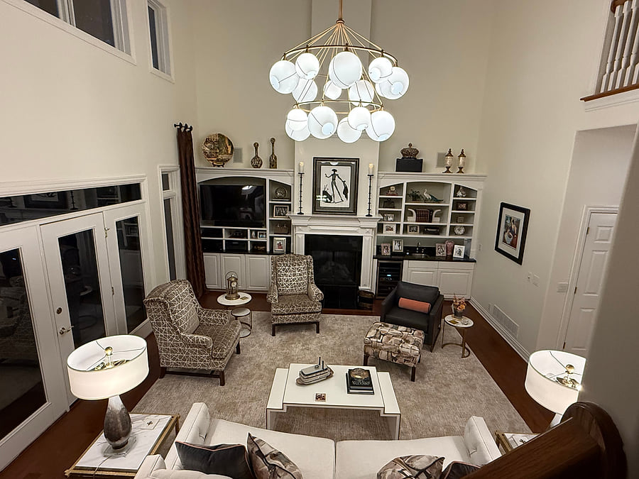 A two-storey great room with reupholstered seating around the fireplace