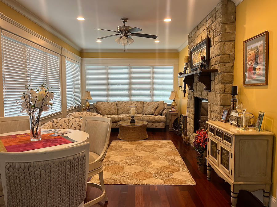 A sunroom before, with bare blinds and no top treatment