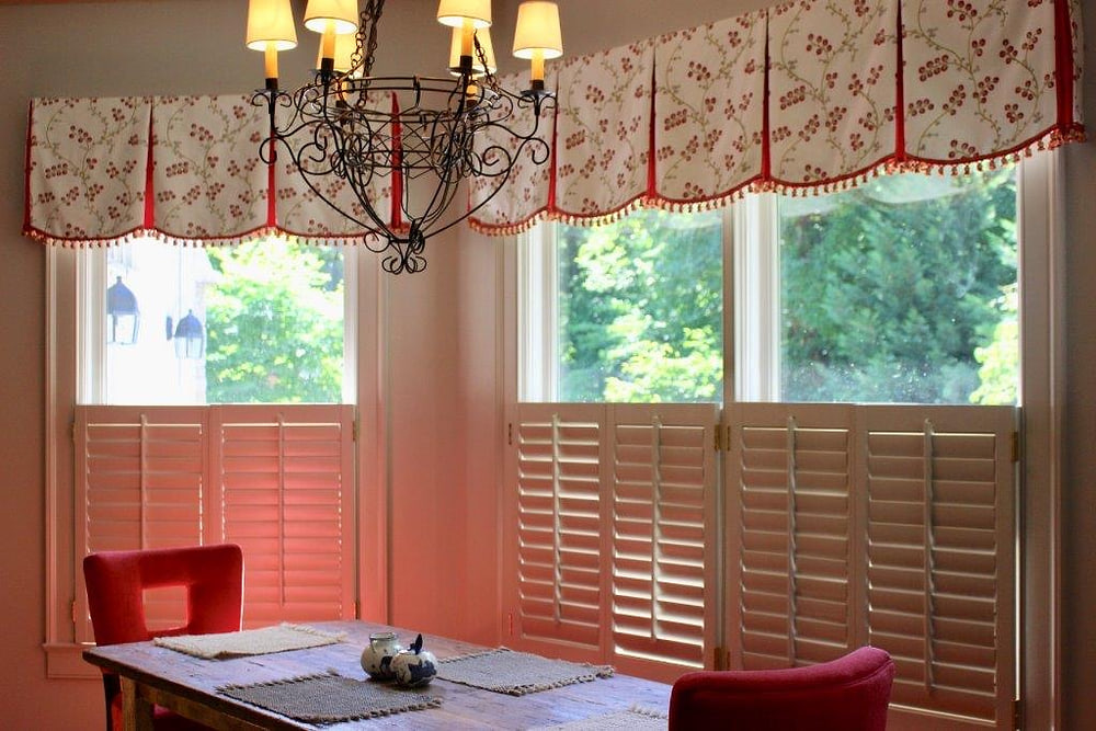 A blue ikat valance with tassel trim above a garden door
