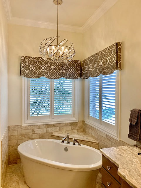 A scalloped valance in blue and white above a window