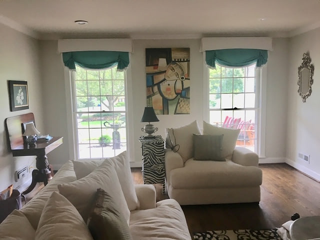Teal cornices above windows in a living room