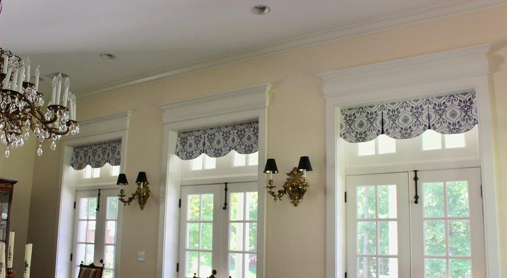 Matching valances running across three tall windows
